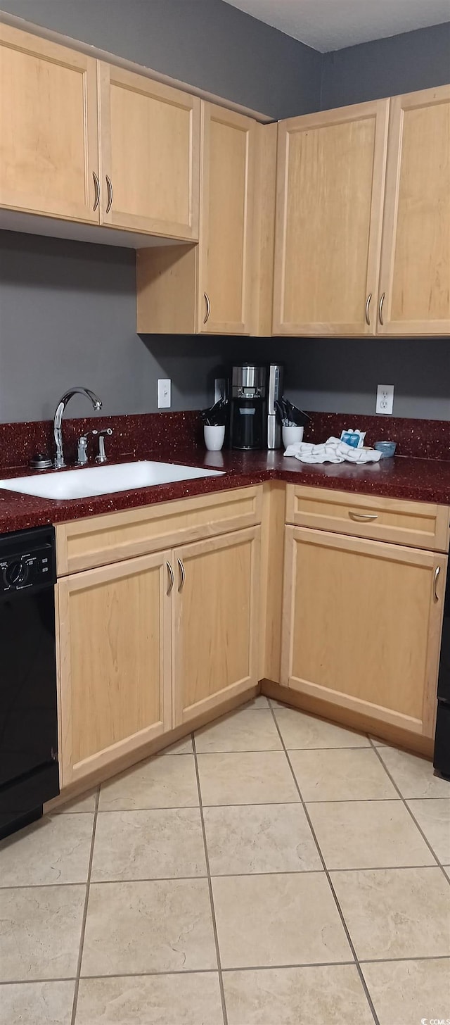 kitchen featuring sink, dishwasher, light tile floors, and light brown cabinetry