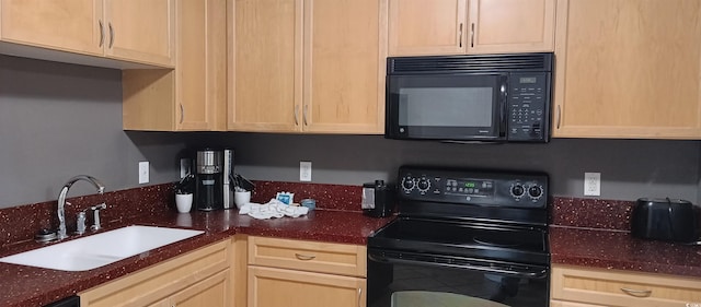 kitchen featuring light brown cabinetry, sink, and range with electric cooktop