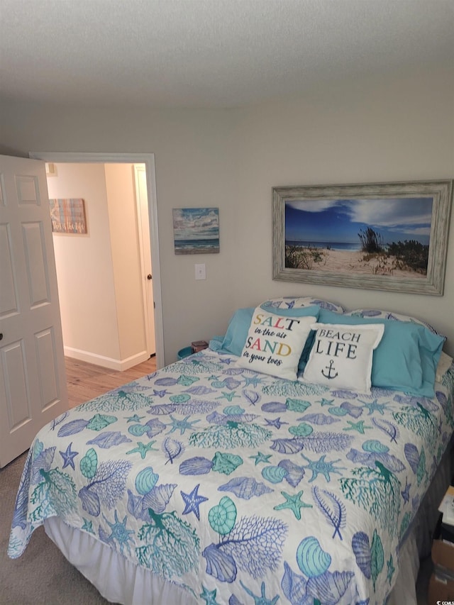 bedroom featuring hardwood / wood-style floors and a textured ceiling