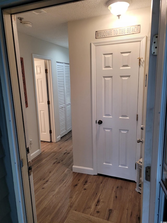 entrance foyer featuring hardwood / wood-style flooring and a textured ceiling