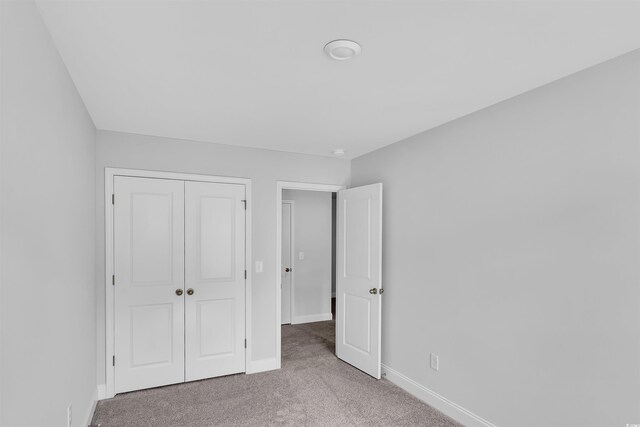 233 Sandridgebury Dr Unit 57, Little River, SC 29566 - unfurnished bedroom featuring carpet flooring, baseboards, and a closet