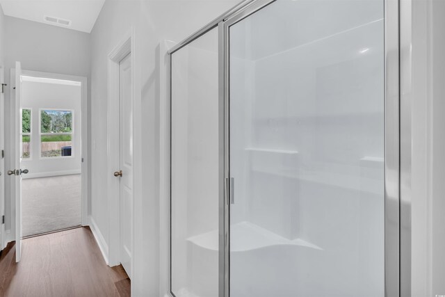 233 Sandridgebury Dr Unit 57, Little River, SC 29566 - full bathroom featuring baseboards, a stall shower, wood finished floors, and visible vents