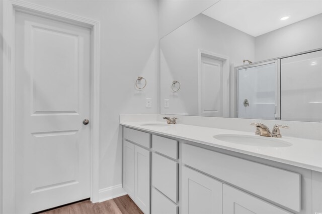 233 Sandridgebury Dr Unit 57, Little River, SC 29566 - bathroom featuring a sink, an enclosed shower, double vanity, and wood finished floors