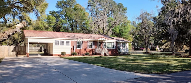 ranch-style home with a front yard and a carport