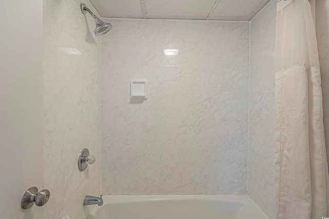 bathroom with shower / bath combo with shower curtain