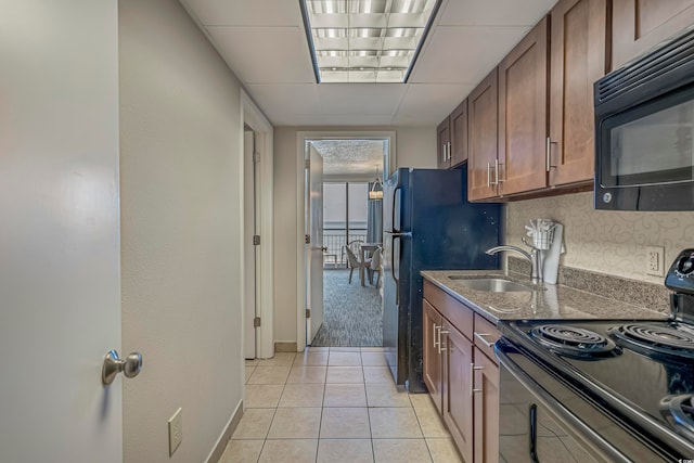 kitchen featuring sink, light carpet, and electric range