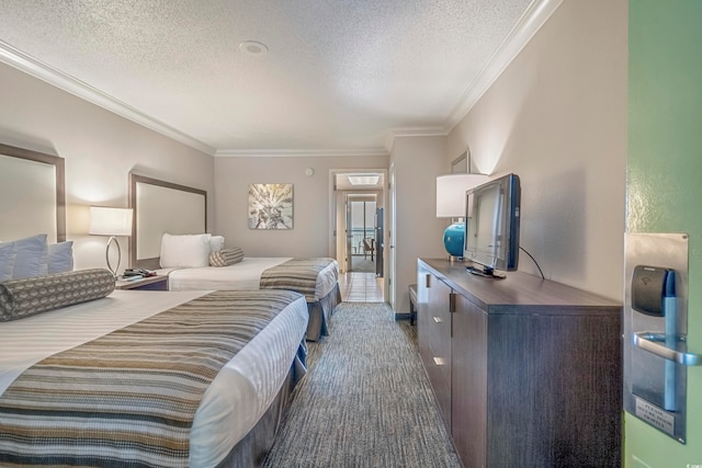 bedroom featuring a textured ceiling, crown molding, and carpet