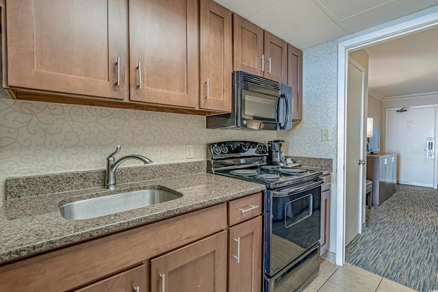 kitchen featuring light stone countertops, black appliances, sink, light carpet, and ornamental molding