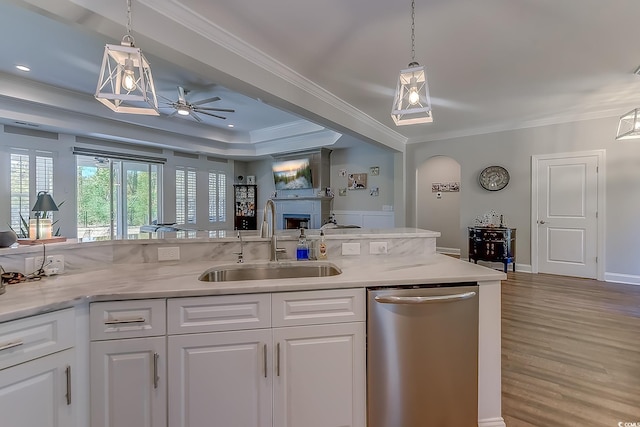 kitchen featuring ceiling fan, stainless steel dishwasher, sink, white cabinetry, and ornamental molding