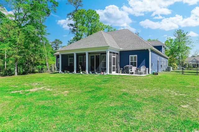 back of house with a lawn, central air condition unit, a patio area, and a sunroom