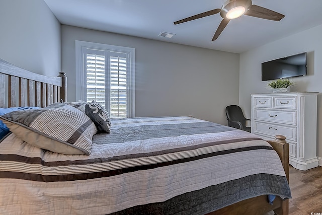 bedroom with ceiling fan and wood-type flooring