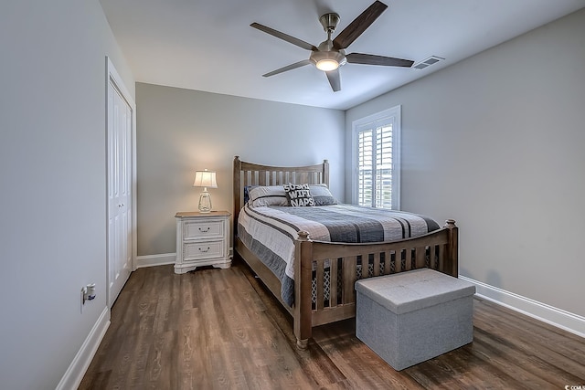 bedroom featuring ceiling fan, a closet, and dark hardwood / wood-style floors