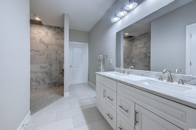 bathroom featuring a tile shower, tile patterned floors, and vanity