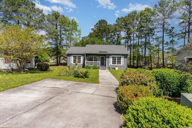 single story home with a front lawn and covered porch