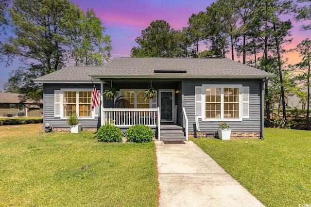 bungalow featuring a lawn and covered porch