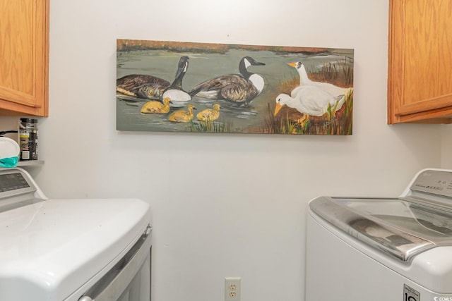 laundry area with cabinets and washing machine and dryer