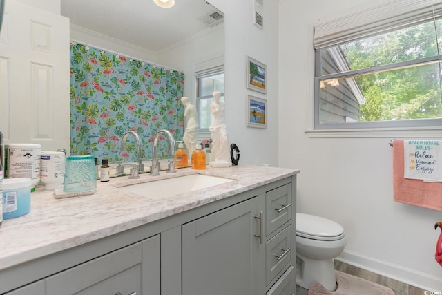 bathroom featuring a shower with curtain, vanity, crown molding, hardwood / wood-style flooring, and toilet