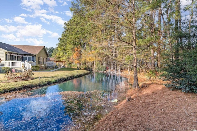 view of yard with a deck with water view