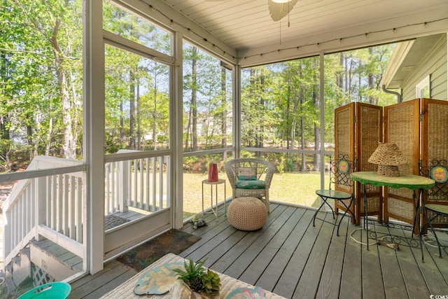 sunroom featuring ceiling fan and wood ceiling