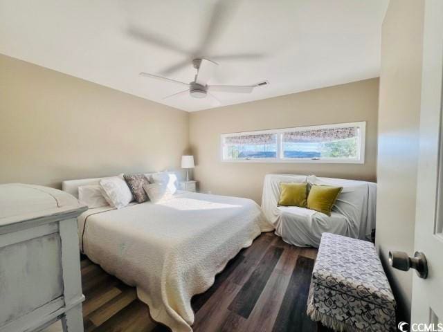 bedroom with dark hardwood / wood-style floors and ceiling fan