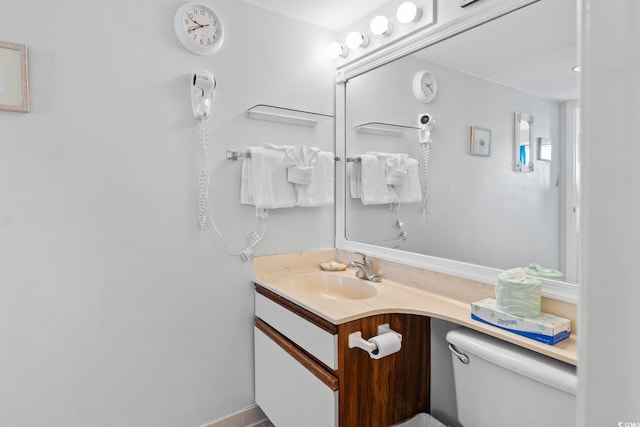 bathroom featuring large vanity and toilet