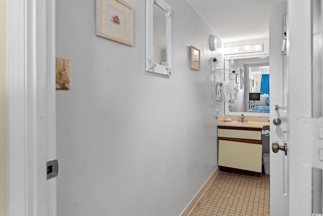 bathroom featuring tile flooring and vanity