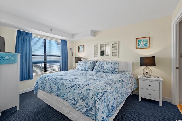 bedroom with dark colored carpet