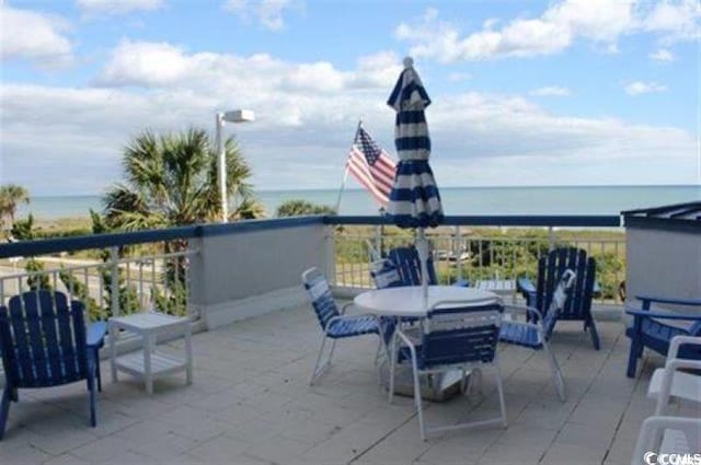 view of patio / terrace with a water view and a balcony