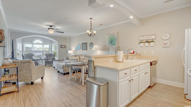 kitchen featuring hanging light fixtures, light hardwood / wood-style floors, white cabinets, beamed ceiling, and sink