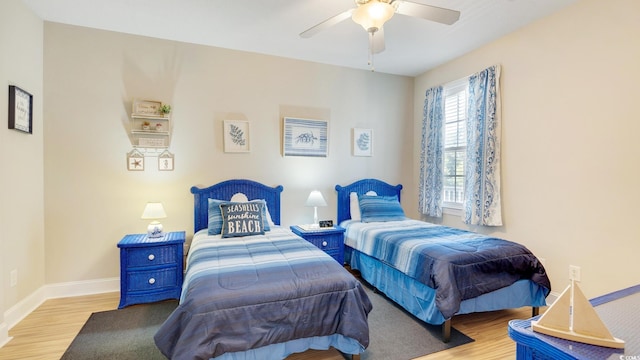 bedroom with light hardwood / wood-style flooring and ceiling fan