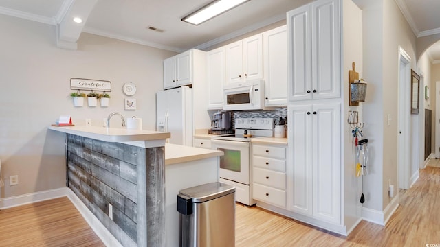 kitchen featuring white cabinets, white appliances, light wood-type flooring, crown molding, and backsplash