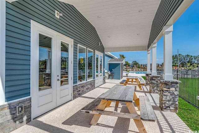 view of patio featuring a pool and french doors