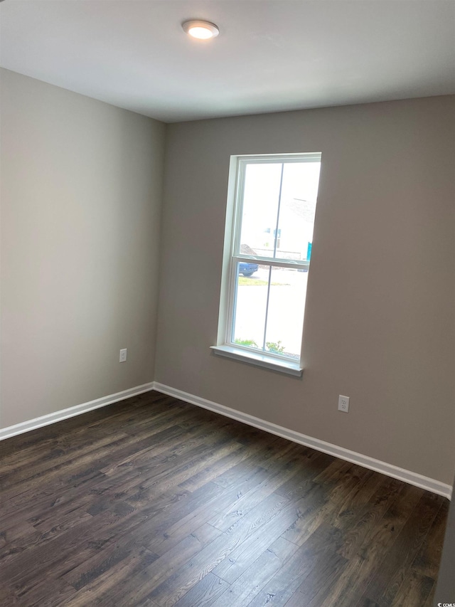 unfurnished room featuring dark hardwood / wood-style flooring