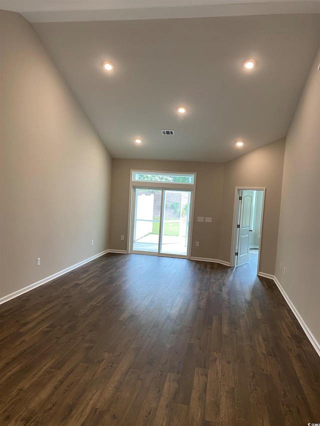 unfurnished room featuring vaulted ceiling and dark hardwood / wood-style floors