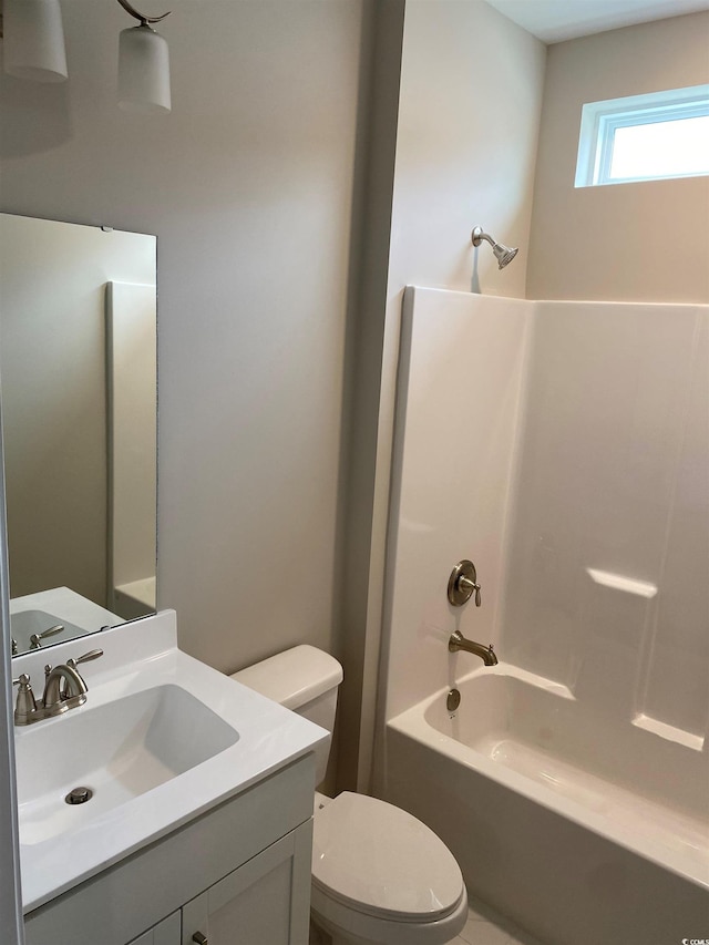 full bathroom featuring toilet, vanity, and shower / bathtub combination