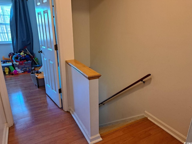 stairway with hardwood / wood-style flooring