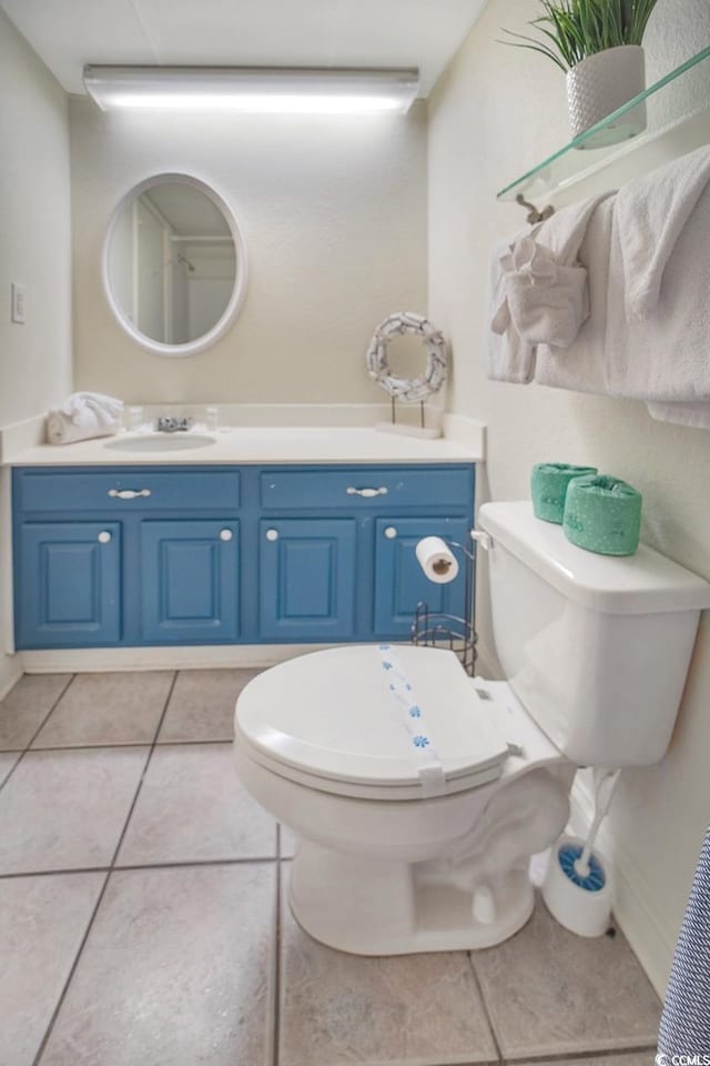 bathroom featuring vanity, toilet, and tile floors