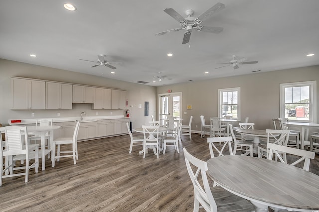 dining room with wood-type flooring and sink