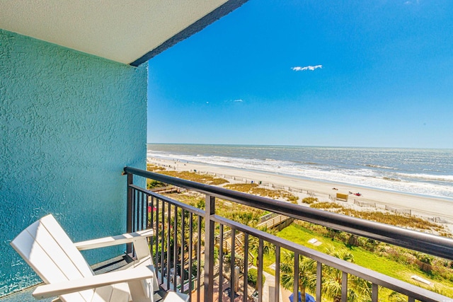 balcony with a beach view and a water view