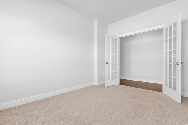 spare room featuring french doors and carpet floors