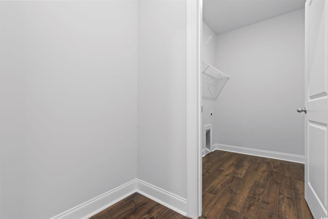 clothes washing area with hookup for an electric dryer and dark hardwood / wood-style flooring