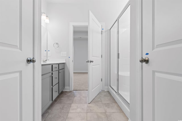 bathroom featuring vanity, tile patterned floors, and a shower with shower door