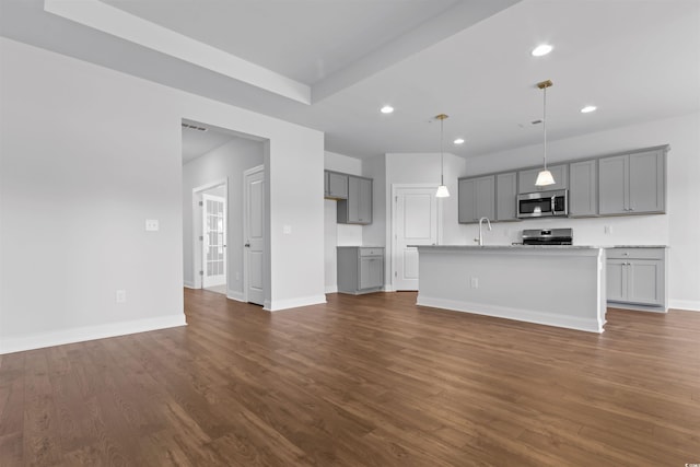 unfurnished living room with dark hardwood / wood-style floors and sink