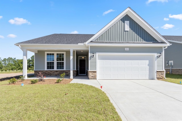 craftsman house with a garage and a front lawn