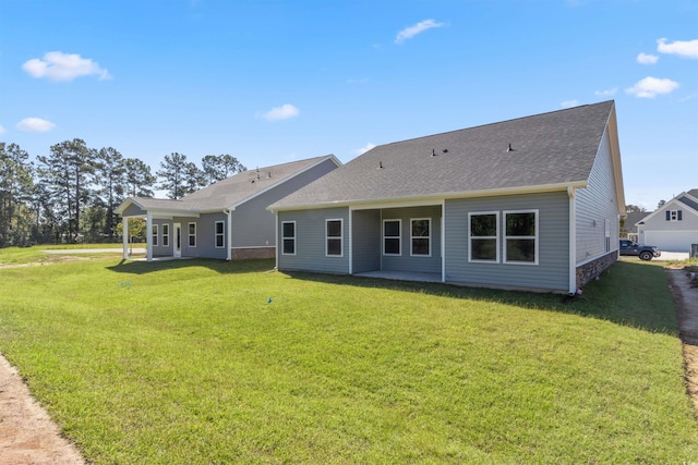 rear view of property featuring a yard