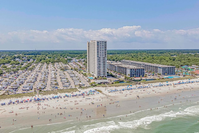 bird's eye view featuring a water view and a beach view