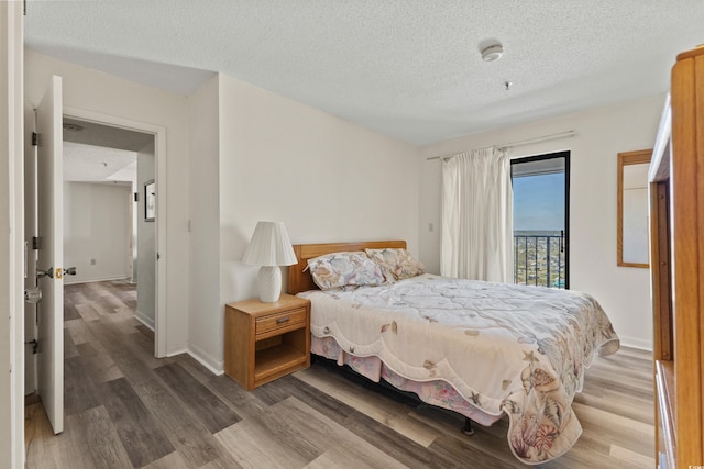 bedroom featuring a textured ceiling and hardwood / wood-style floors