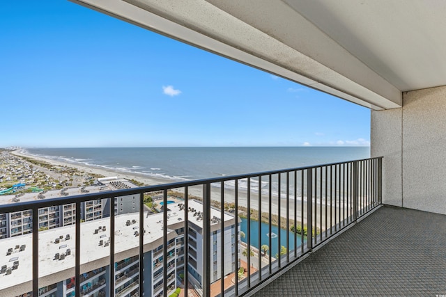 balcony featuring a view of the beach and a water view