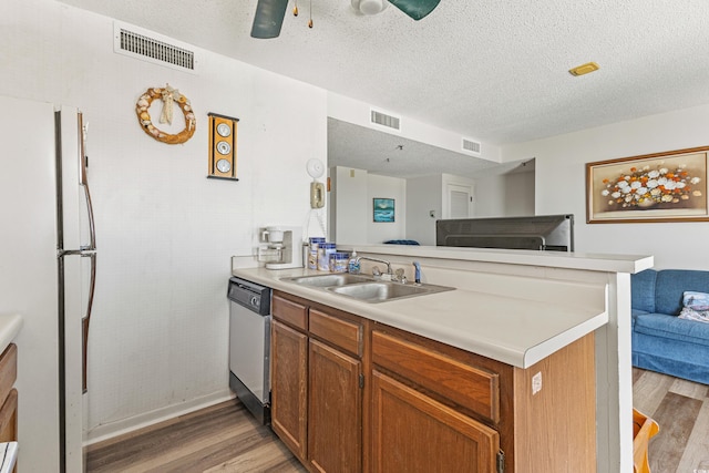 kitchen with ceiling fan, dishwasher, light wood-type flooring, and white fridge