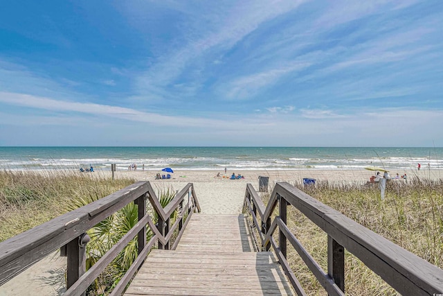 view of property's community with a view of the beach and a water view